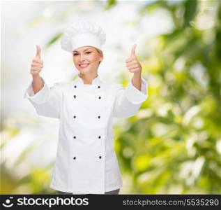 cooking, gesture and food concept - smiling female chef, cook or baker showing thumbs up
