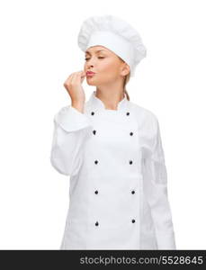 cooking, gesture and food concept - smiling female chef showing delicious gesture