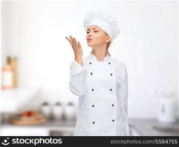 cooking, gesture and food concept - smiling female chef showing delicious gesture