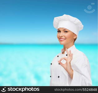 cooking, gesture and food concept - smiling female chef showing ok hand sign