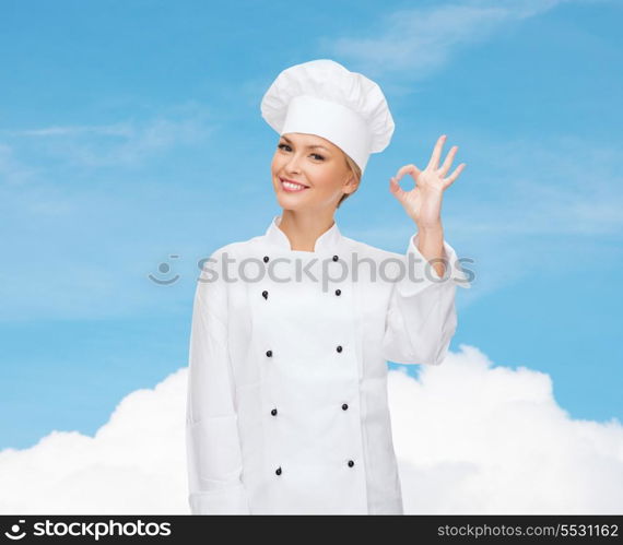 cooking, gesture and food concept - smiling female chef showing ok hand sign