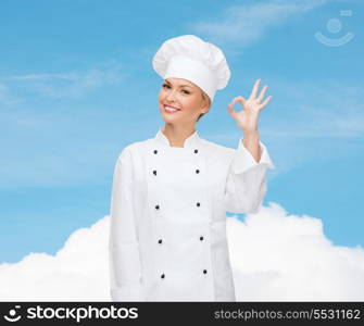 cooking, gesture and food concept - smiling female chef showing ok hand sign