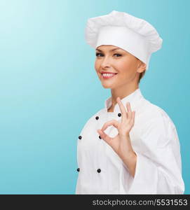 cooking, gesture and food concept - smiling female chef showing ok hand sign