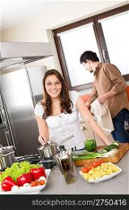 Cooking - happy couple in modern kitchen cook together