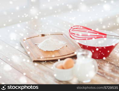 cooking, home and food concept - close up of milk jug, eggs in a bowl, whisk and flour
