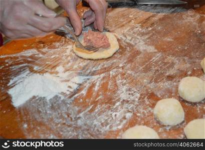 Cooking homemade whites with meat on a yeast dough
