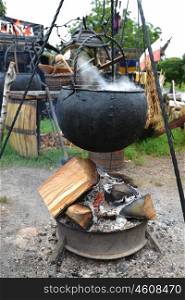 cooking in big pot on campfire