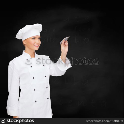 cooking, new techology , advertisement and food concept - smiling female chef, cook or baker with marker writing something on virtual screen