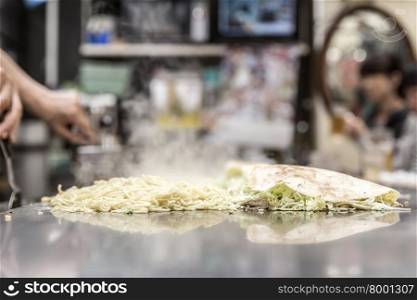 cooking of okonomiyaki japanese pizza