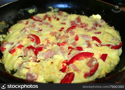 cooking of omelet with red paprika . cooking of omelet with red paprika and sausage