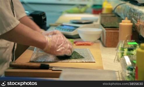 Cooking Of Salmon Sushi Roll In Catering.