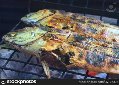 Cooking of salted fish on a grill stove