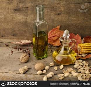 Cooking Oil And Autumn Items On Wooden Background