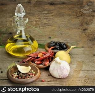 Cooking Oil And Spices On Wooden Background