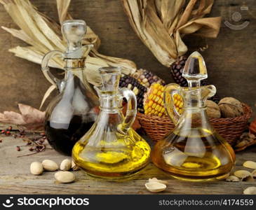 Cooking Oil , Vinegar And Autumn Items On Wooden Background