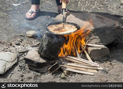 cooking pancake on the campfire