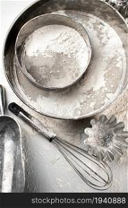 Cooking pastries at home. Sieve, rolling pin and flour. Top view. On a white background.. Cooking pastries at home. Sieve, rolling pin and flour. Top view.
