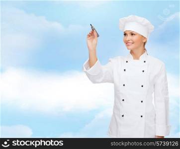 cooking, people, advertisement and concept - smiling female chef, cook or baker with marker writing something on virtual screen over blue cloudy sky background