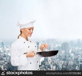 cooking, people and food concept - smiling female chef with pan and spoon mixing food over city background