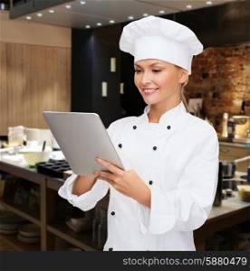 cooking, people, technology and food concept - smiling female chef, cook or baker with tablet pc computer over restaurant kitchen background