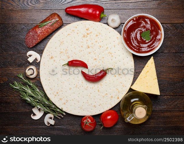 Cooking pizza with fresh ingredients - dough, salami, sauce, cheese, tomato, mushrooms, pepper