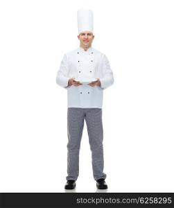 cooking, profession, advertisement and people concept - happy male chef cook showing something on empty plate
