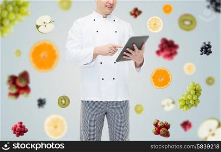 cooking, profession and people concept - close up of happy male chef cook holding tablet pc computer over fruits and berries on gray background