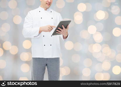 cooking, profession and people concept - close up of happy male chef cook holding tablet pc computer over holidays lights background