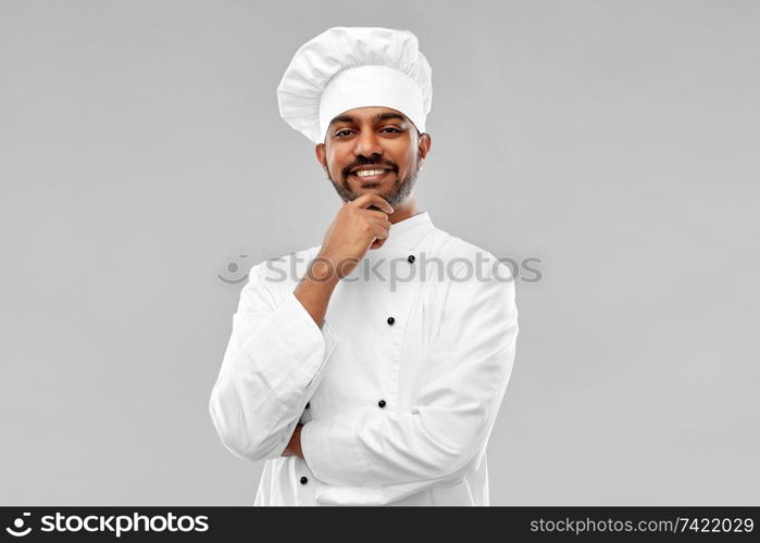 cooking, profession and people concept - happy male indian chef in toque over grey background. happy male indian chef in toque