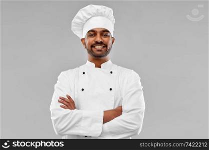cooking, profession and people concept - happy male indian chef in toque over grey background. happy male indian chef in toque