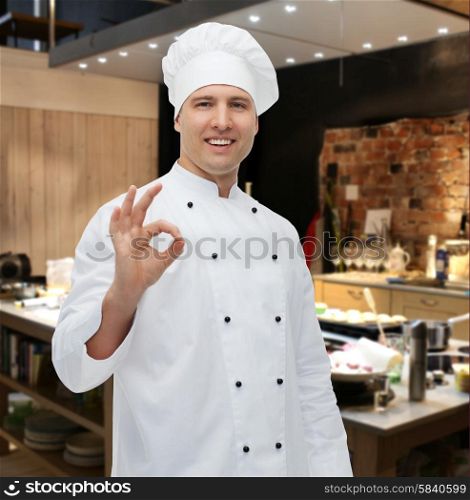 cooking, profession, gesture and people concept - happy male chef cook showing ok sign over kitchen background