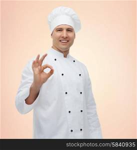 cooking, profession, gesture and people concept - happy male chef cook showing ok sign over beige background