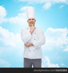 cooking, profession, inspiration and people concept - happy male chef cook thinking over blue sky with clouds background