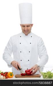 cooking, profession, vegetarian, food and people concept - happy male chef chopping pepper