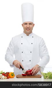 cooking, profession, vegetarian, food and people concept - happy male chef chopping pepper