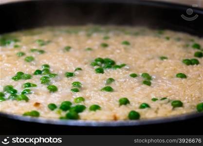 cooking rice with green pea on a frying pan