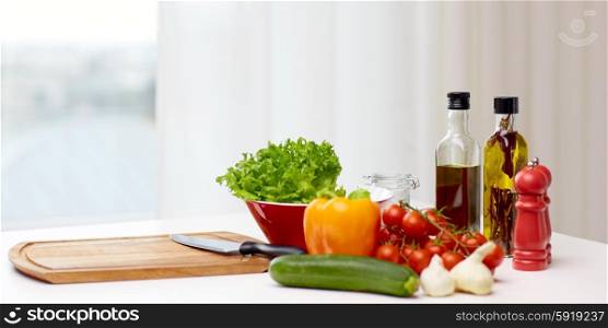 cooking, still life, food and healthy eating concept - fresh ripe vegetables, spices and kitchenware on table in kitchen