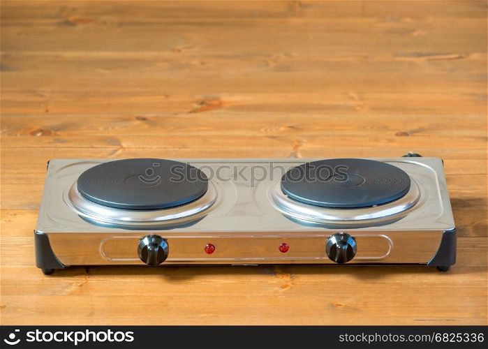 cooking stove with two burners on a dark floor closeup