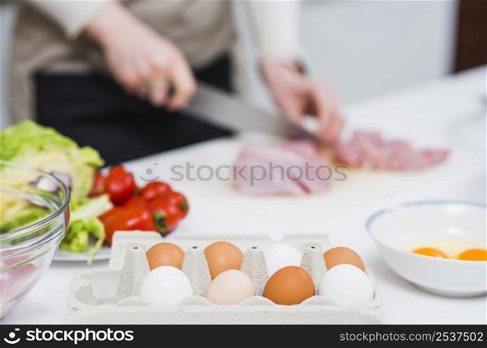 cooking table with ingredients person preparing food