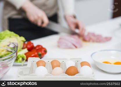 cooking table with ingredients person preparing food