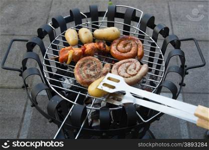 Cooking tasteful meat on a barbecue outside during winter