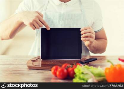 cooking, technology, advertising and home concept - close up of male hands holding tablet pc with blank black screen and pointing to it