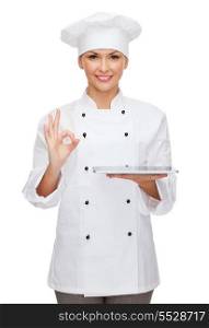 cooking, technology and food concept - smiling female chef, cook or baker with tablet pc computer and ok sign