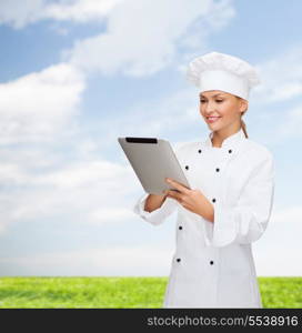 cooking, technology and food concept - smiling female chef, cook or baker with tablet pc computer