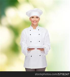 cooking, technology and people concept - smiling female chef, cook or baker with tablet pc computer over green background