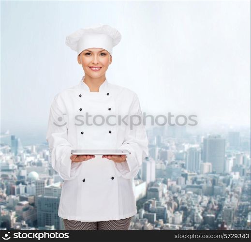 cooking, technology and people concept - smiling female chef, cook or baker with tablet pc computer over city background