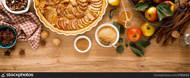 Cooking Thanksgiving autumn apple pie with fresh fruits and walnuts on wooden background, top view. Banner.. Cooking Thanksgiving autumn apple pie with fresh fruits and walnuts on wooden background, top view