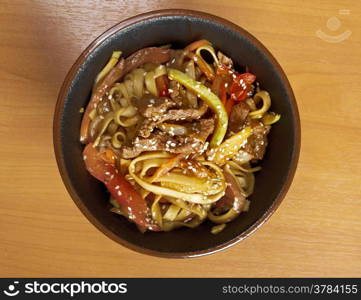 Cooking udon teppanyaki with pork , japanese cuisine