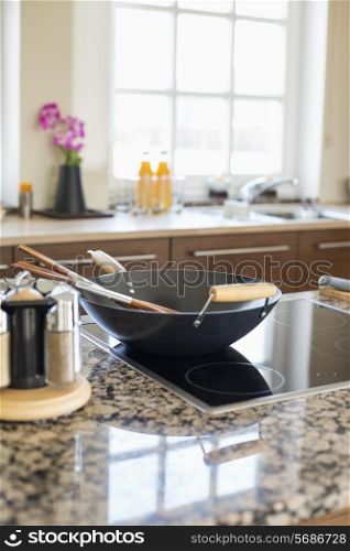 Cooking utensils on stove in kitchen
