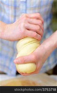 Cooking: woman hands kneading dough, close-up shot